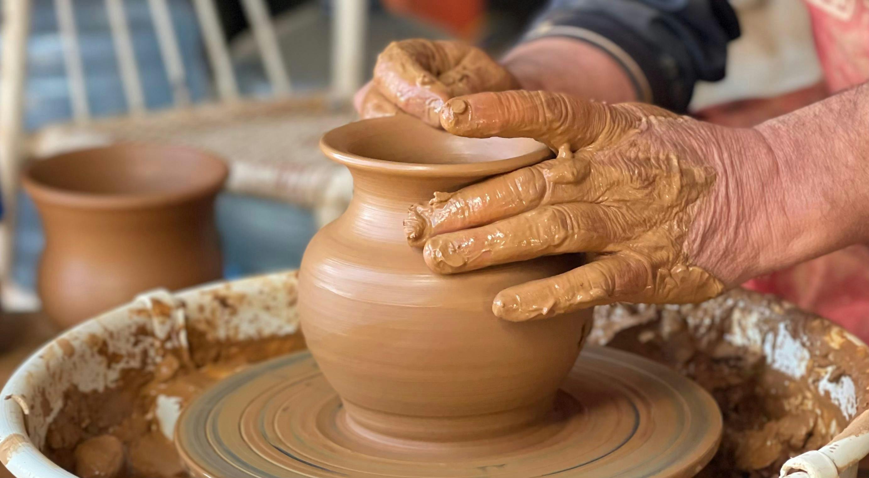 Clay being thrown on the wheel